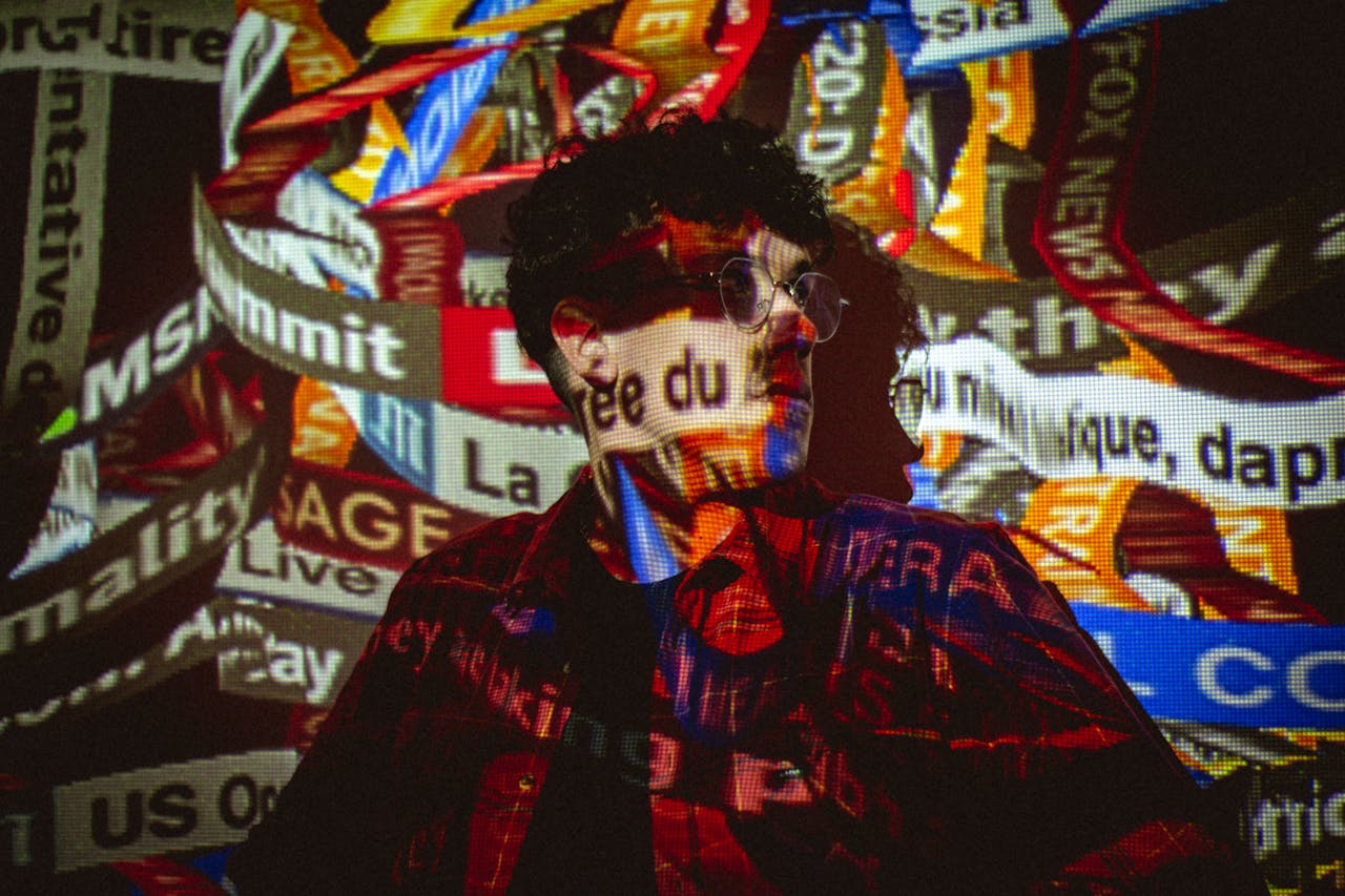 Conceptual photo of a person with news ticker projections on their face and body.